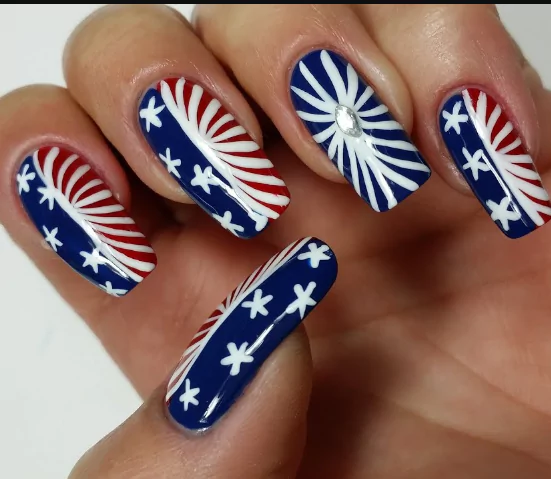 Patriotic Chic Elegance Patriotic chic elegance nails with red, white, and blue designs, featuring stars and stripes for a stylish 4th of July nail look.
