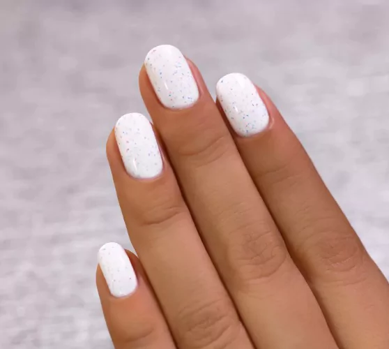 Pristine White: The Clean-Girl Flex That Never Fails White and neutral invisible French tips with blooming-gel floral accents for a soft look