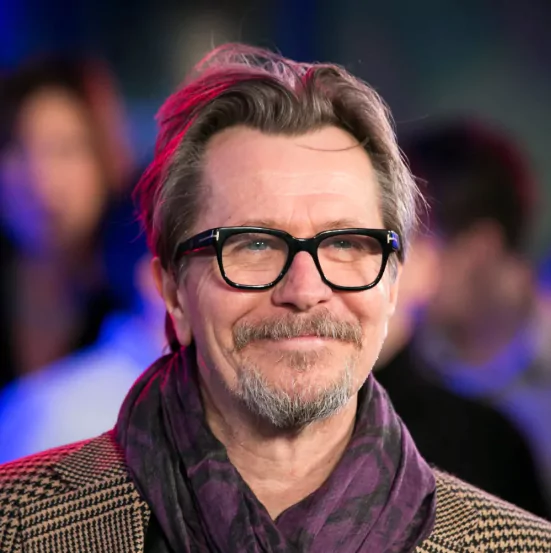 Gary Oldman: Medium Length Hairstyle With Widow's Peak
Gary Oldman with a medium-length brushed-back hairstyle that emphasizes his widow’s peak, styled with subtle volume and a classic, refined look