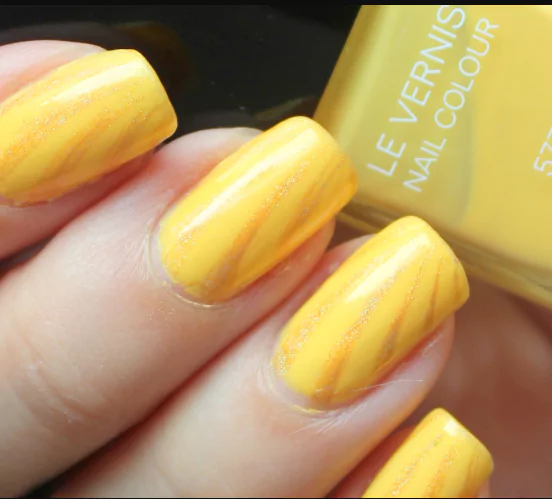 Sunshine Yellow: The Happiness Hack in Nail Form Lemon yellow nails with polka dots, inspired by Hailey Bieber’s citrus manicure trend