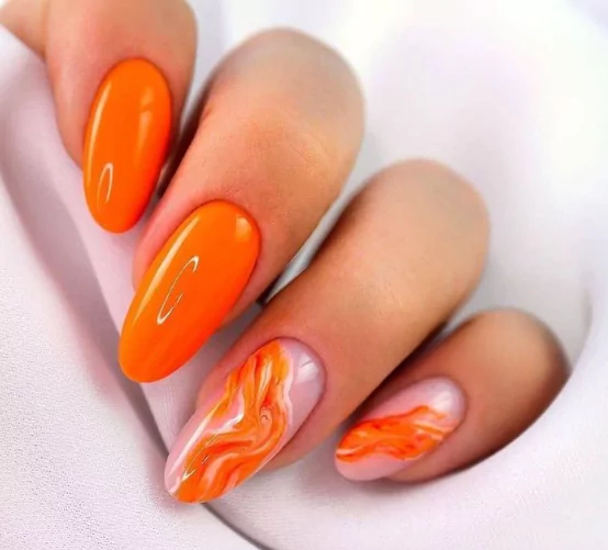 Fiery Orange: The Confidence Booster That Commands Attention Bold orange and pink French tip nails with sculpted floral design for a summer pop